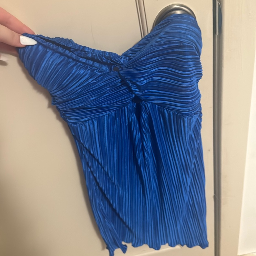 A blue top with a strap in the back